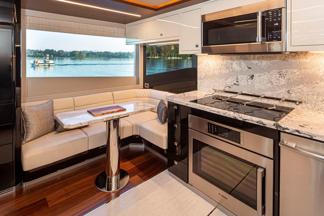 a kitchen with a table and stove aboard 90R03 Yacht for Sale