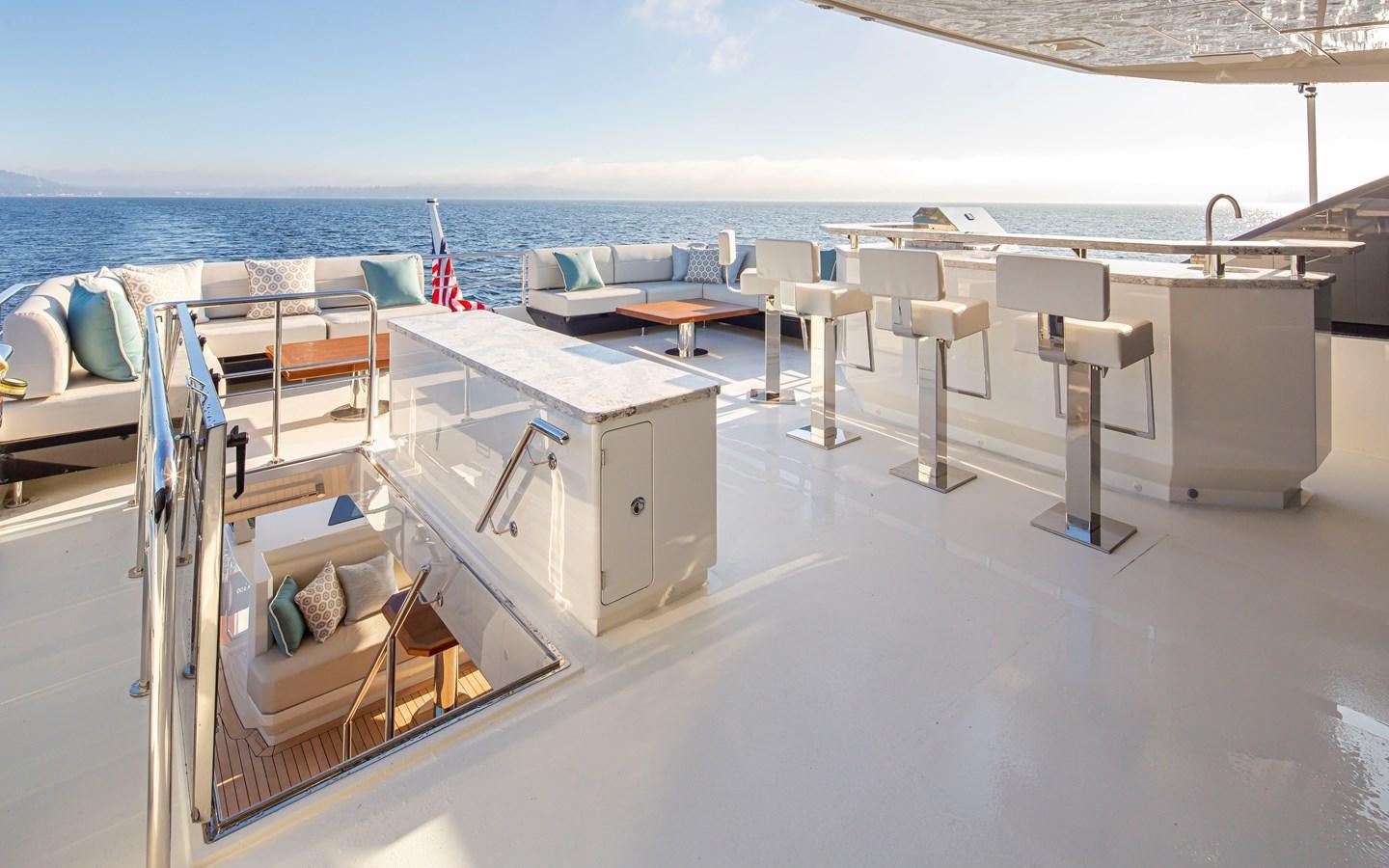 a deck with chairs and tables on it aboard 90R03 Yacht for Sale