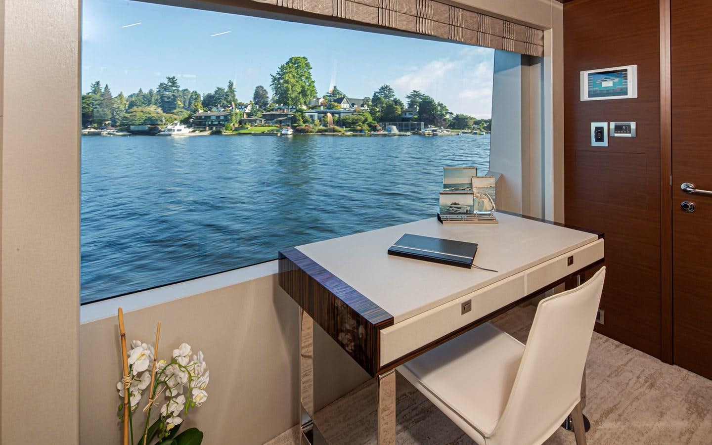 a table with a laptop on it aboard 90R03 Yacht for Sale