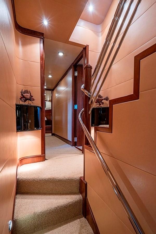 a hallway with a staircase and a television aboard GRAND LEGACY Yacht for Sale