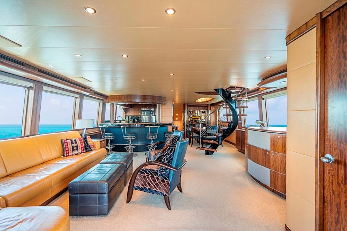 a living room with a couch and a table aboard GRAND LEGACY Yacht for Sale