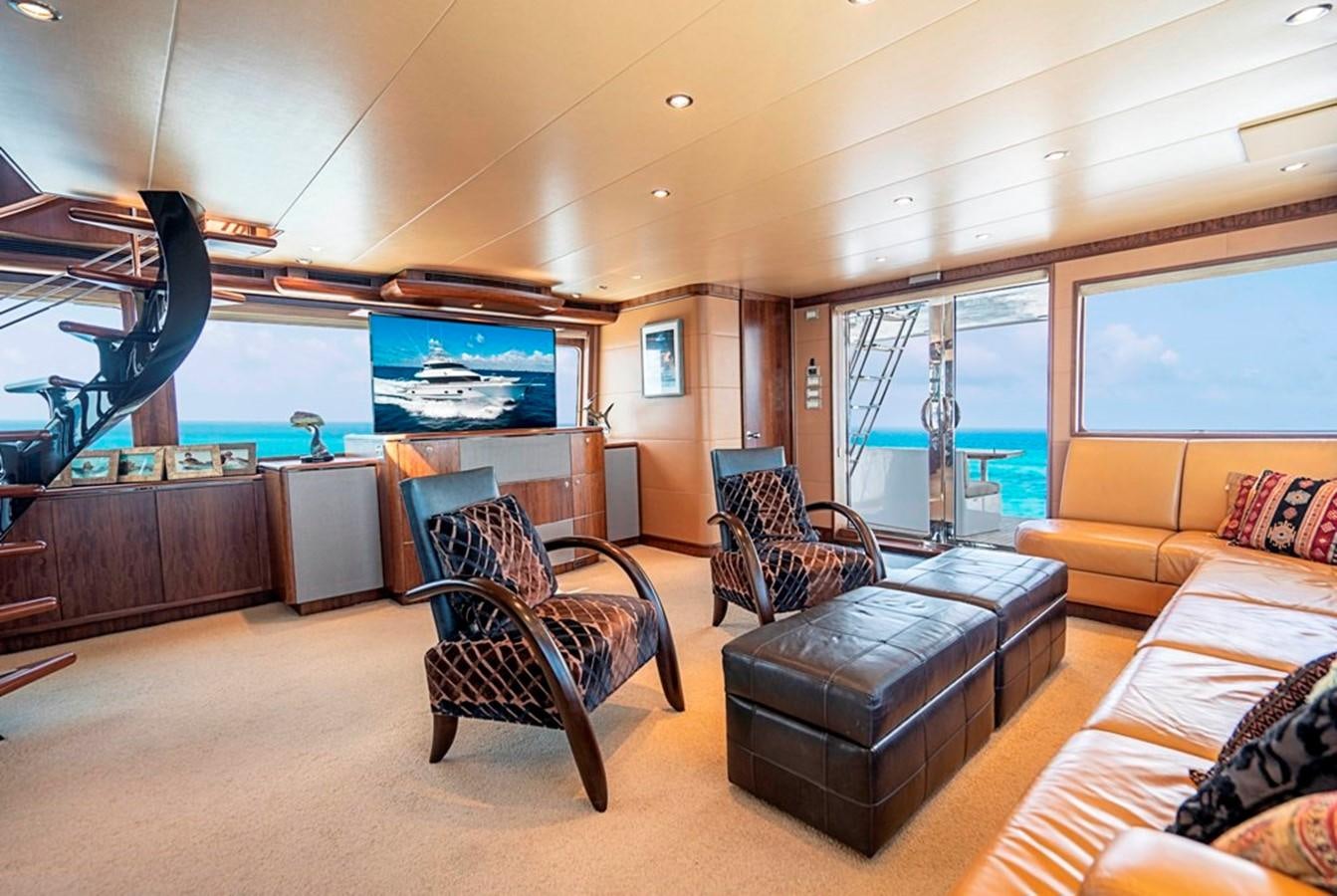 a living room with a large screen aboard GRAND LEGACY Yacht for Sale