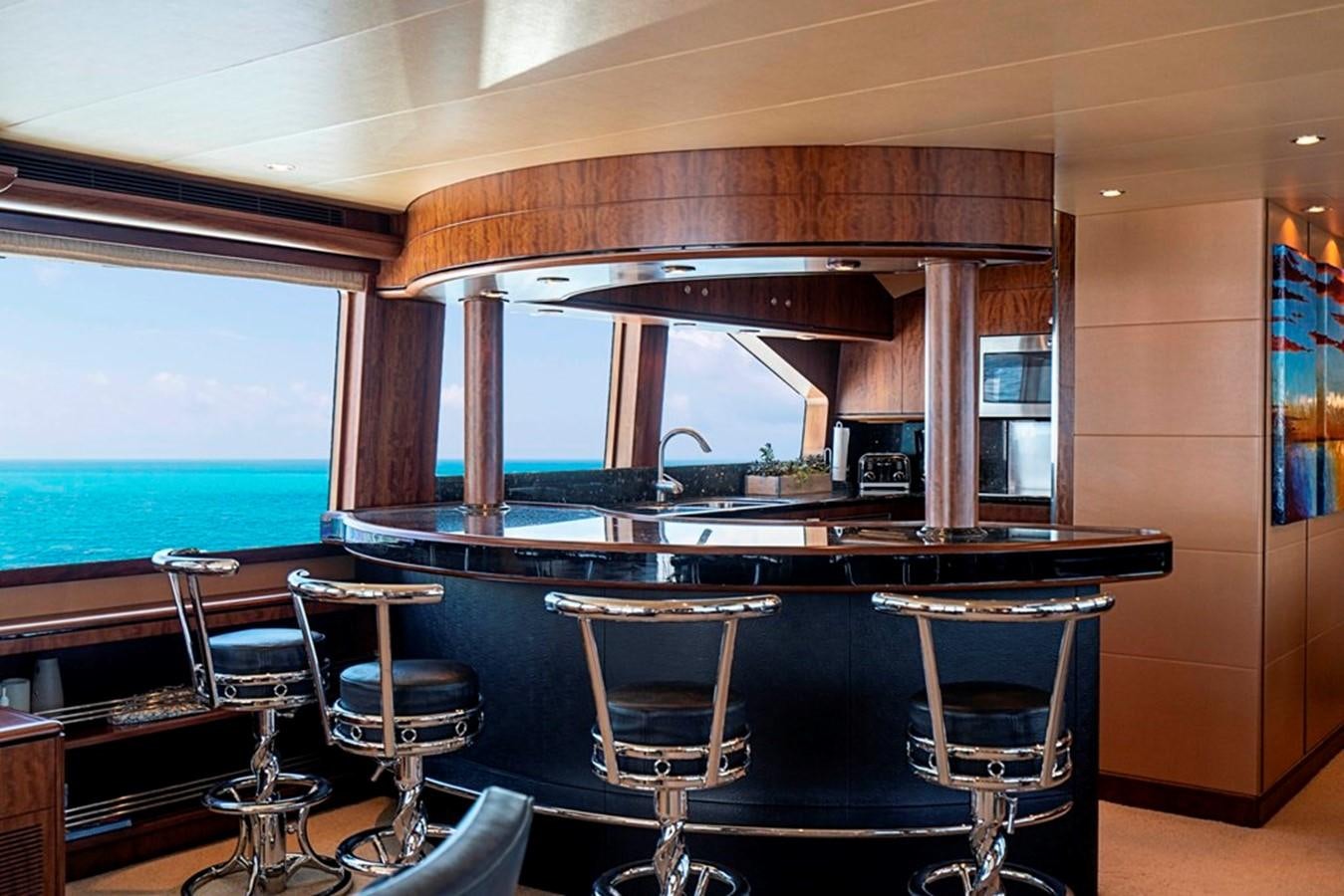 a bar with a table and chairs aboard GRAND LEGACY Yacht for Sale
