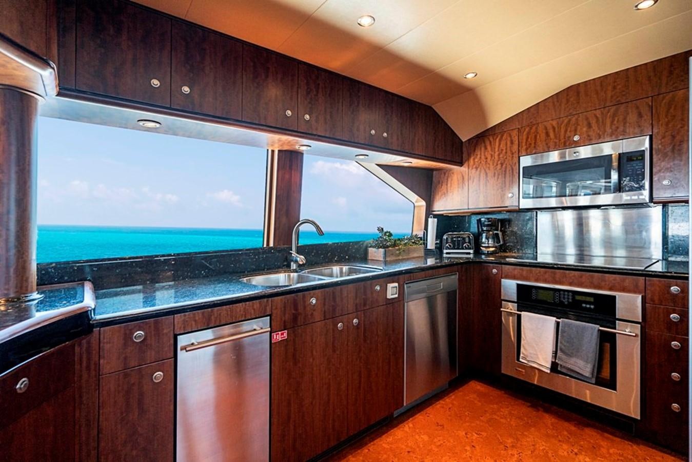 a kitchen with black cabinets aboard GRAND LEGACY Yacht for Sale