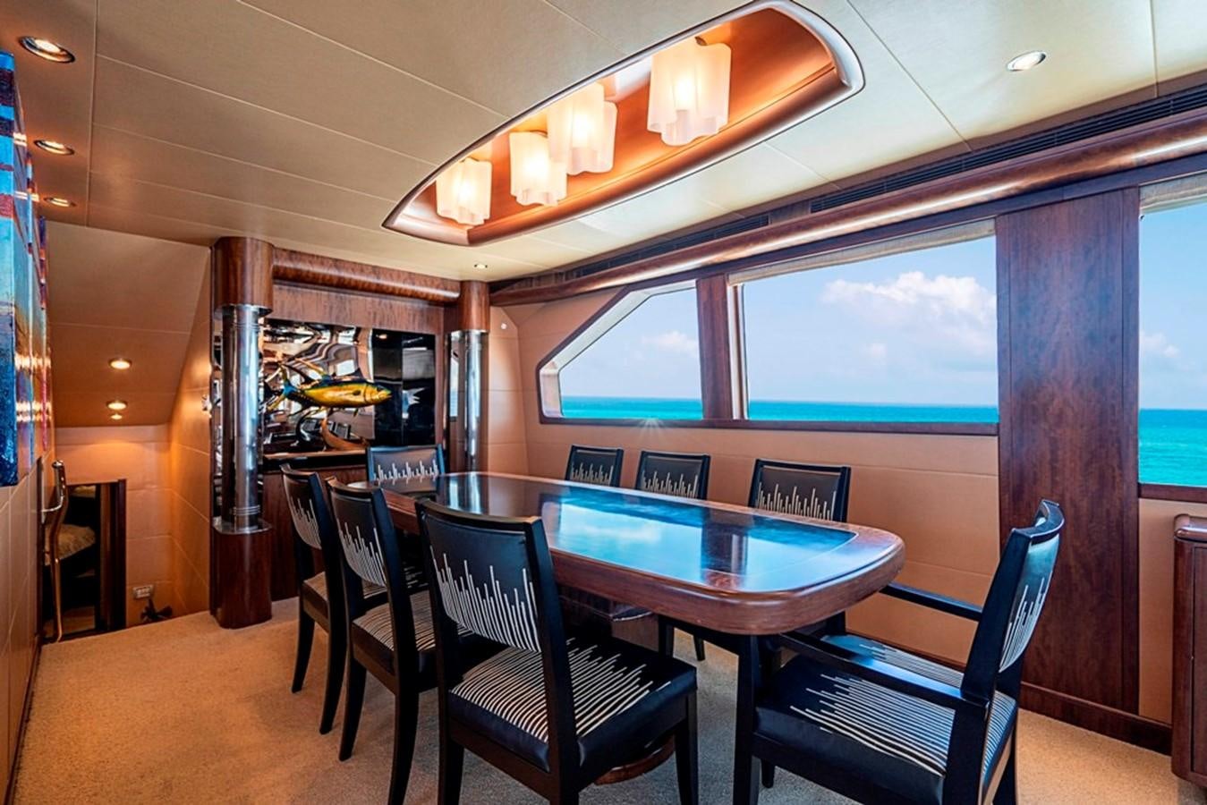 a dining room with a table and chairs aboard GRAND LEGACY Yacht for Sale