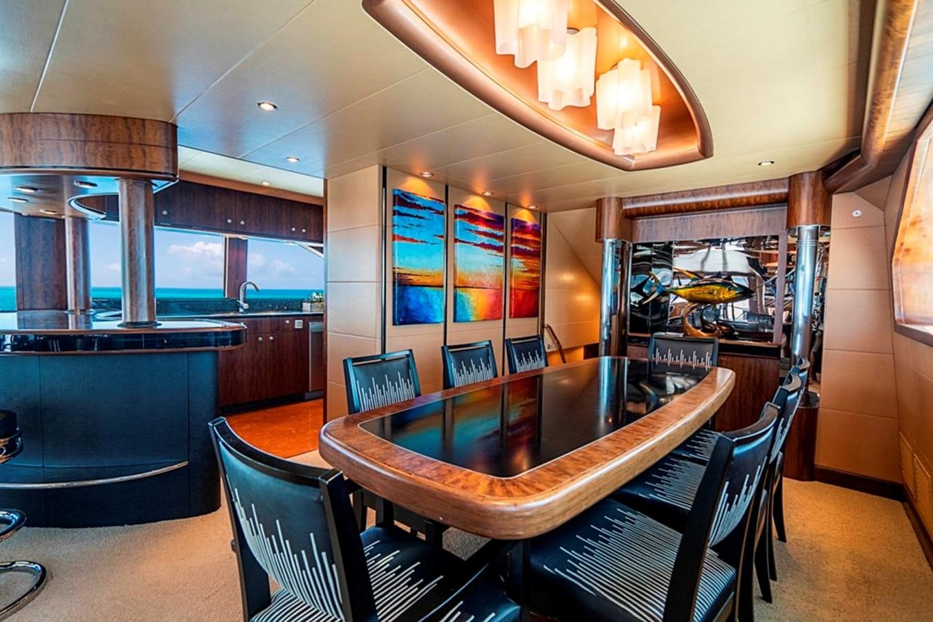 a room with a table and chairs aboard GRAND LEGACY Yacht for Sale