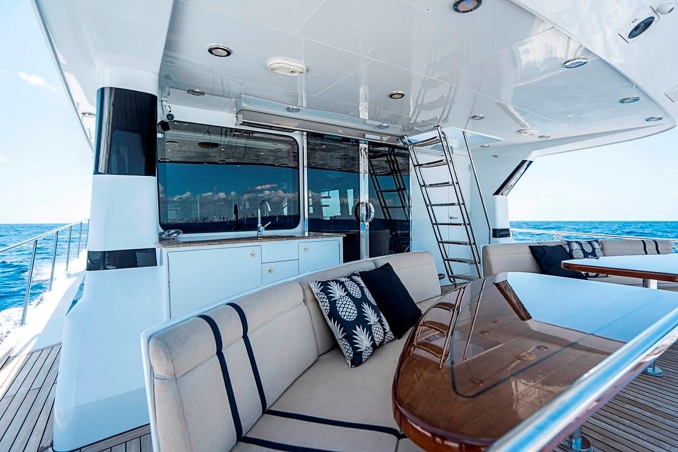 a boat with a couch and a table on it aboard GRAND LEGACY Yacht for Sale