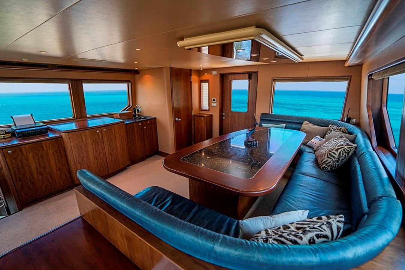 a living room with a couch and a coffee table aboard GRAND LEGACY Yacht for Sale