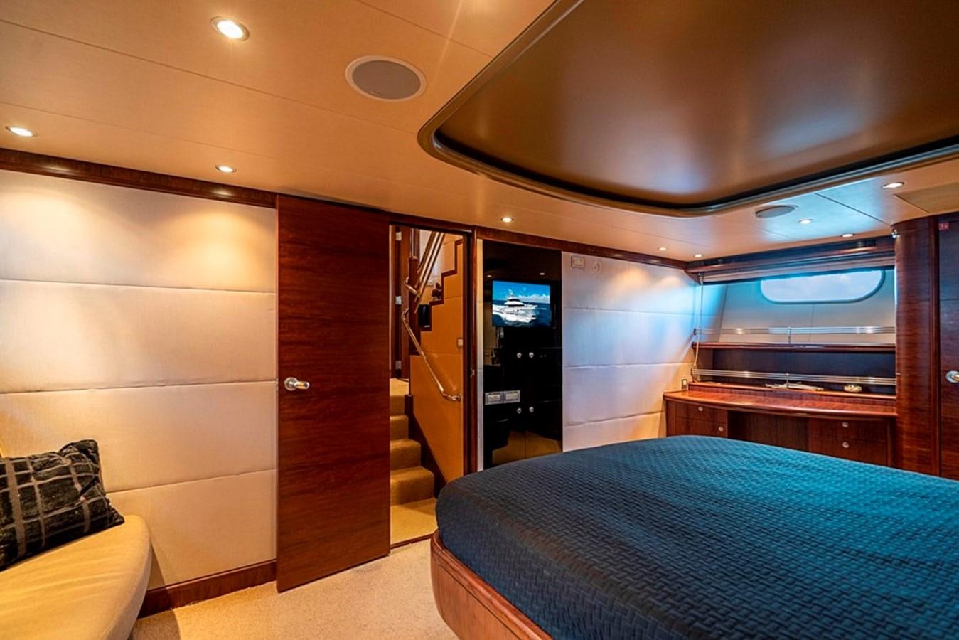 a bedroom with a bed and a closet aboard GRAND LEGACY Yacht for Sale