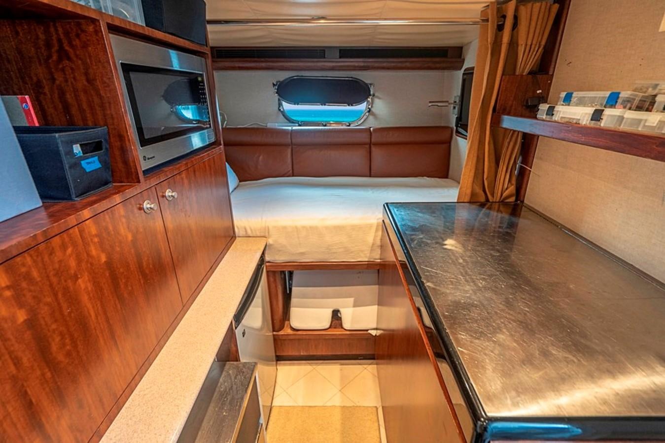 a living room with a tv and a table aboard GRAND LEGACY Yacht for Sale