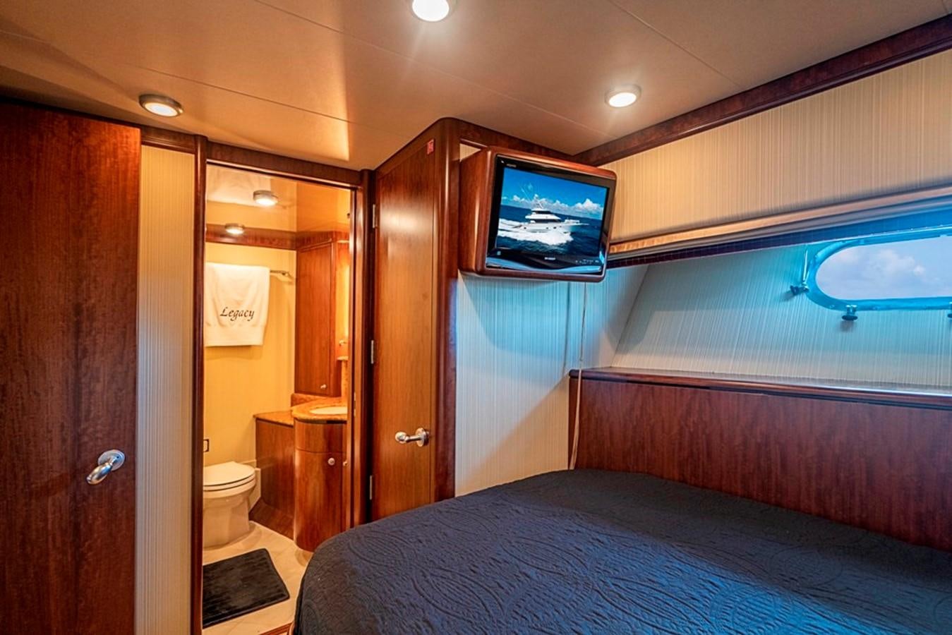 a bedroom with a bed and a television aboard GRAND LEGACY Yacht for Sale