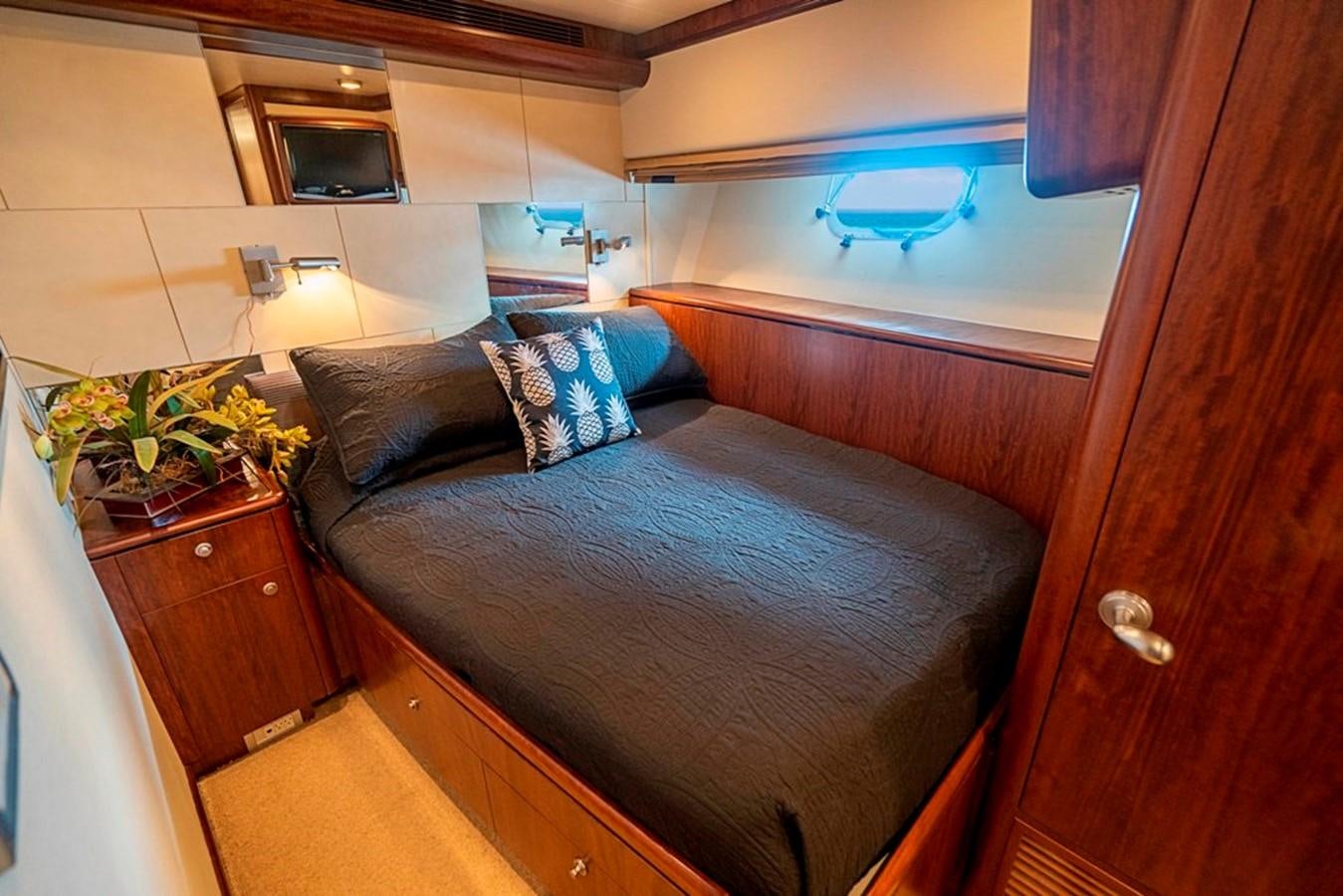 a bed with a blue comforter aboard GRAND LEGACY Yacht for Sale