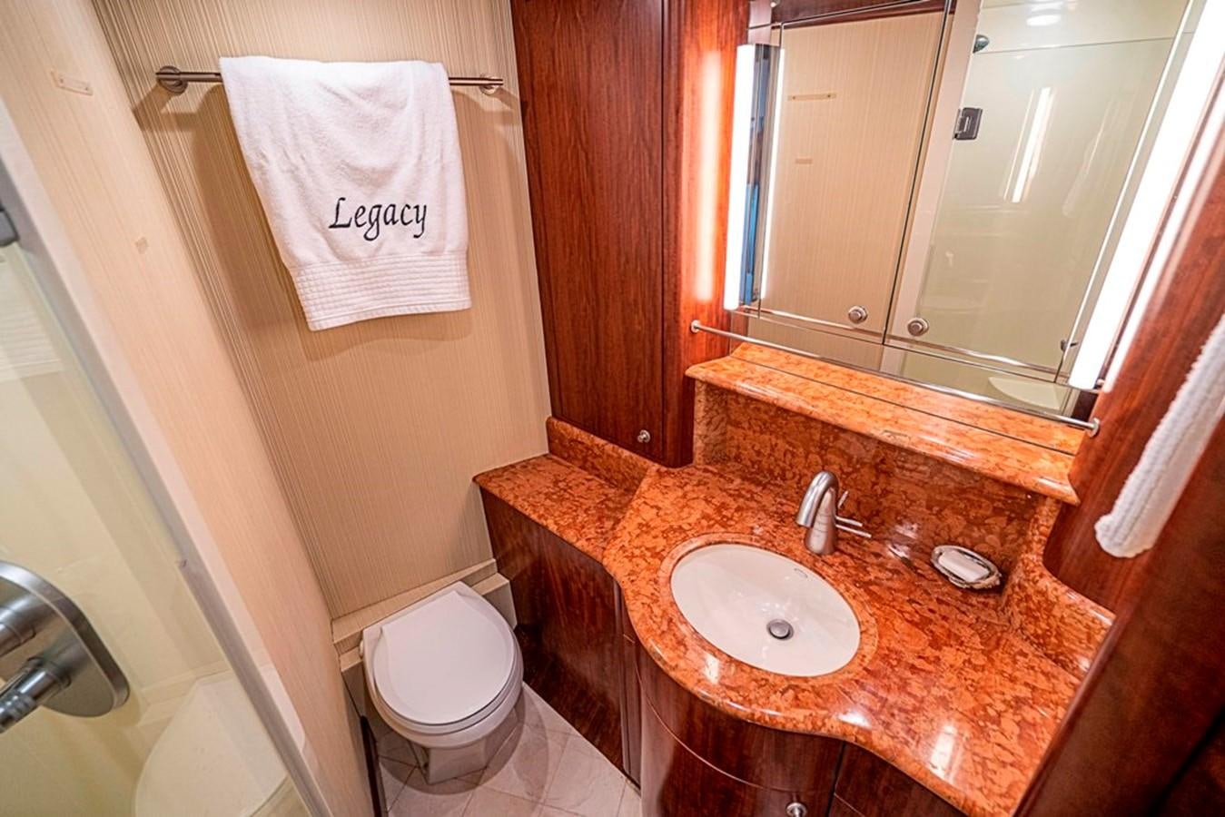 a bathroom with a sink toilet and a mirror aboard GRAND LEGACY Yacht for Sale