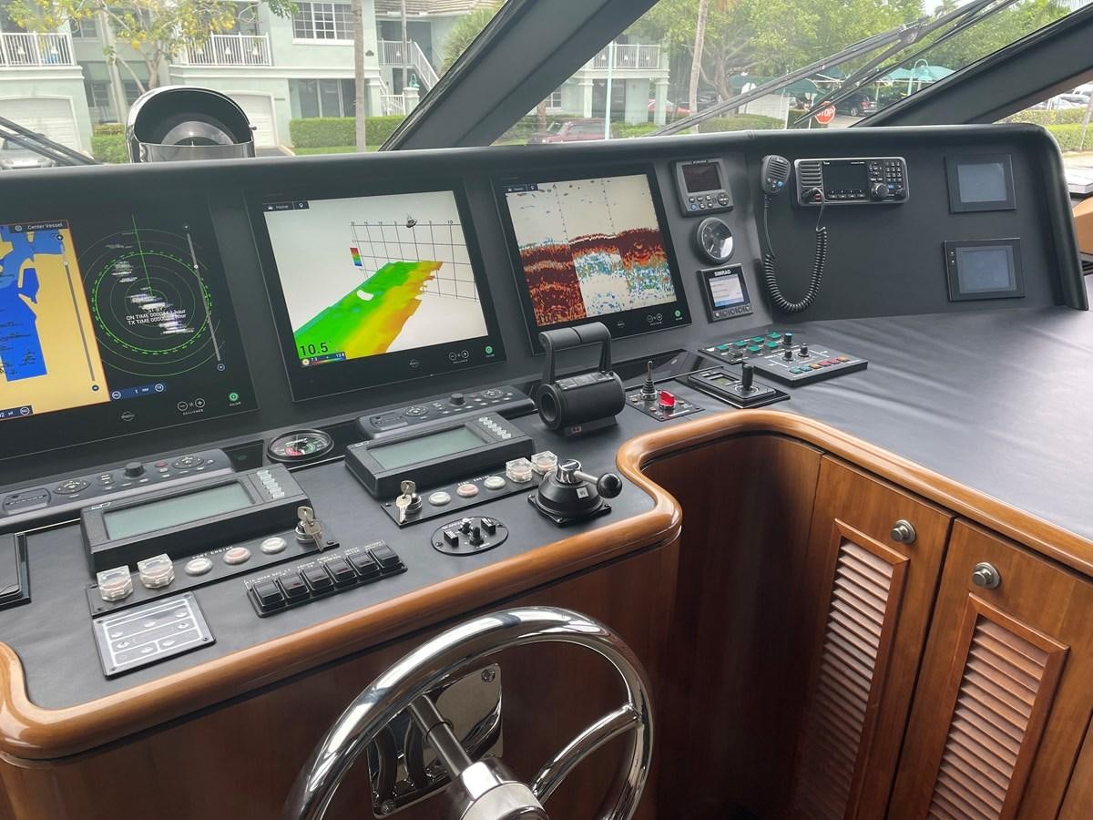 a control panel with multiple monitors aboard GRAND LEGACY Yacht for Sale