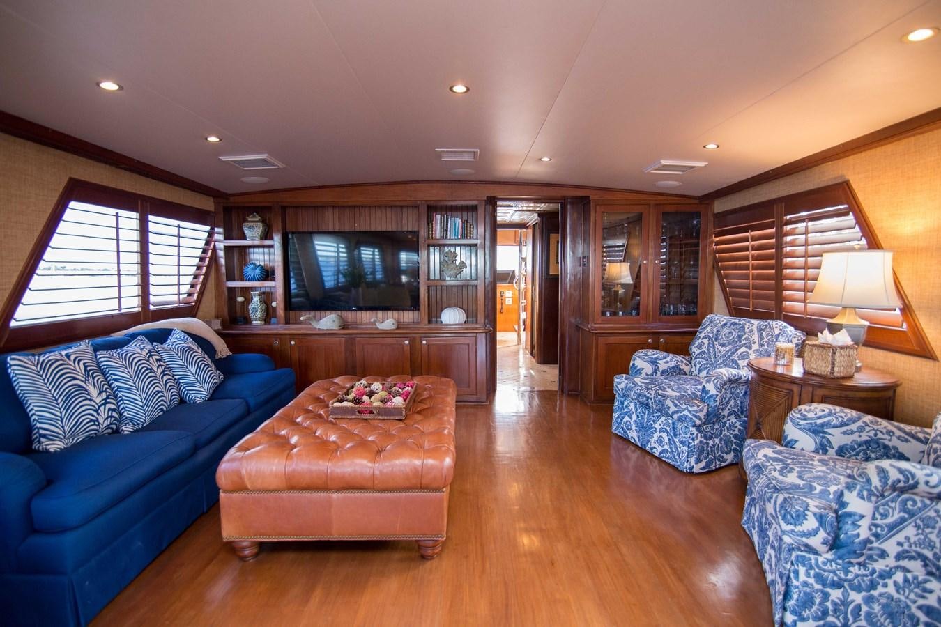a living room with a blue couch aboard NEXT DEAL Yacht for Sale