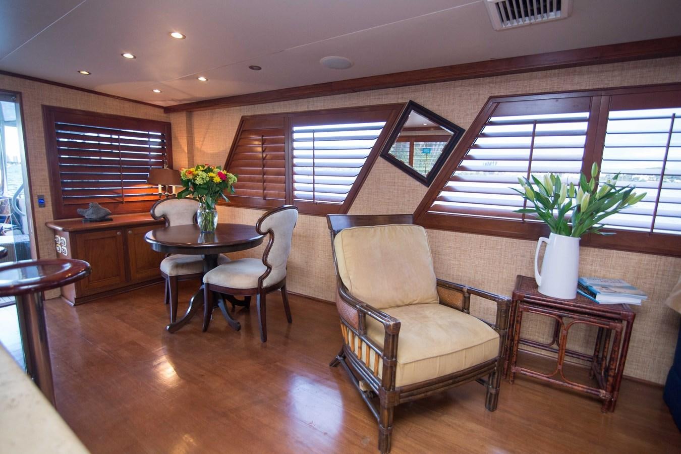 a living room with a table and chairs aboard NEXT DEAL Yacht for Sale