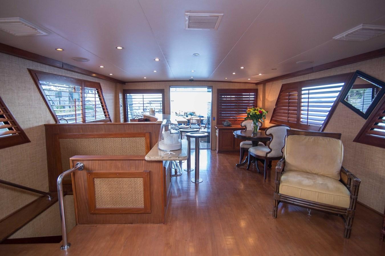 a room with a table chairs and a window aboard NEXT DEAL Yacht for Sale