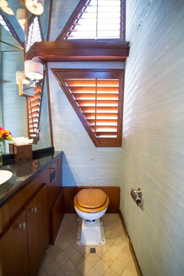 a bathroom with a toilet and a window aboard NEXT DEAL Yacht for Sale