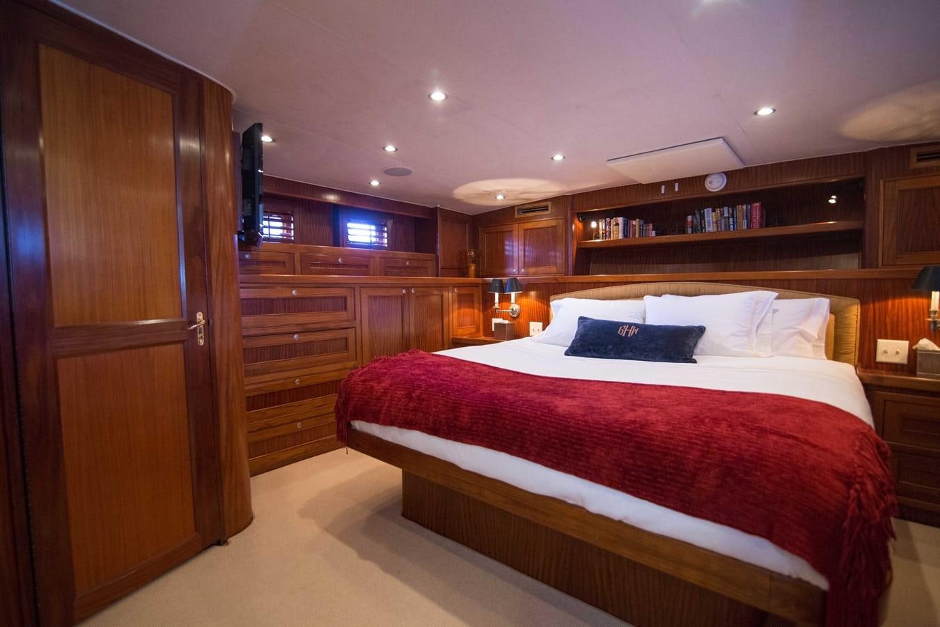 a bedroom with a bed and a closet aboard NEXT DEAL Yacht for Sale