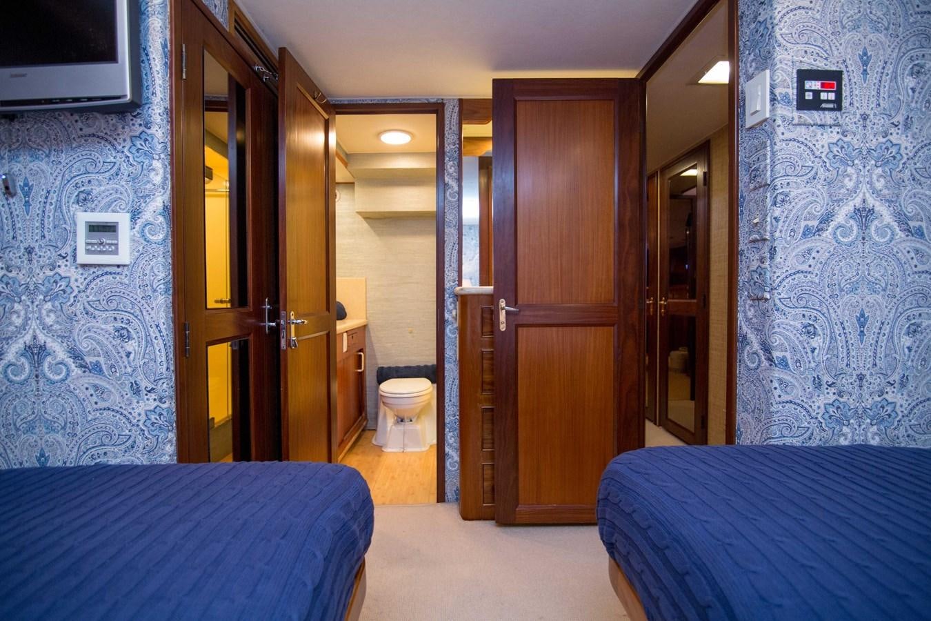 a bedroom with a bed and a blue bed aboard NEXT DEAL Yacht for Sale