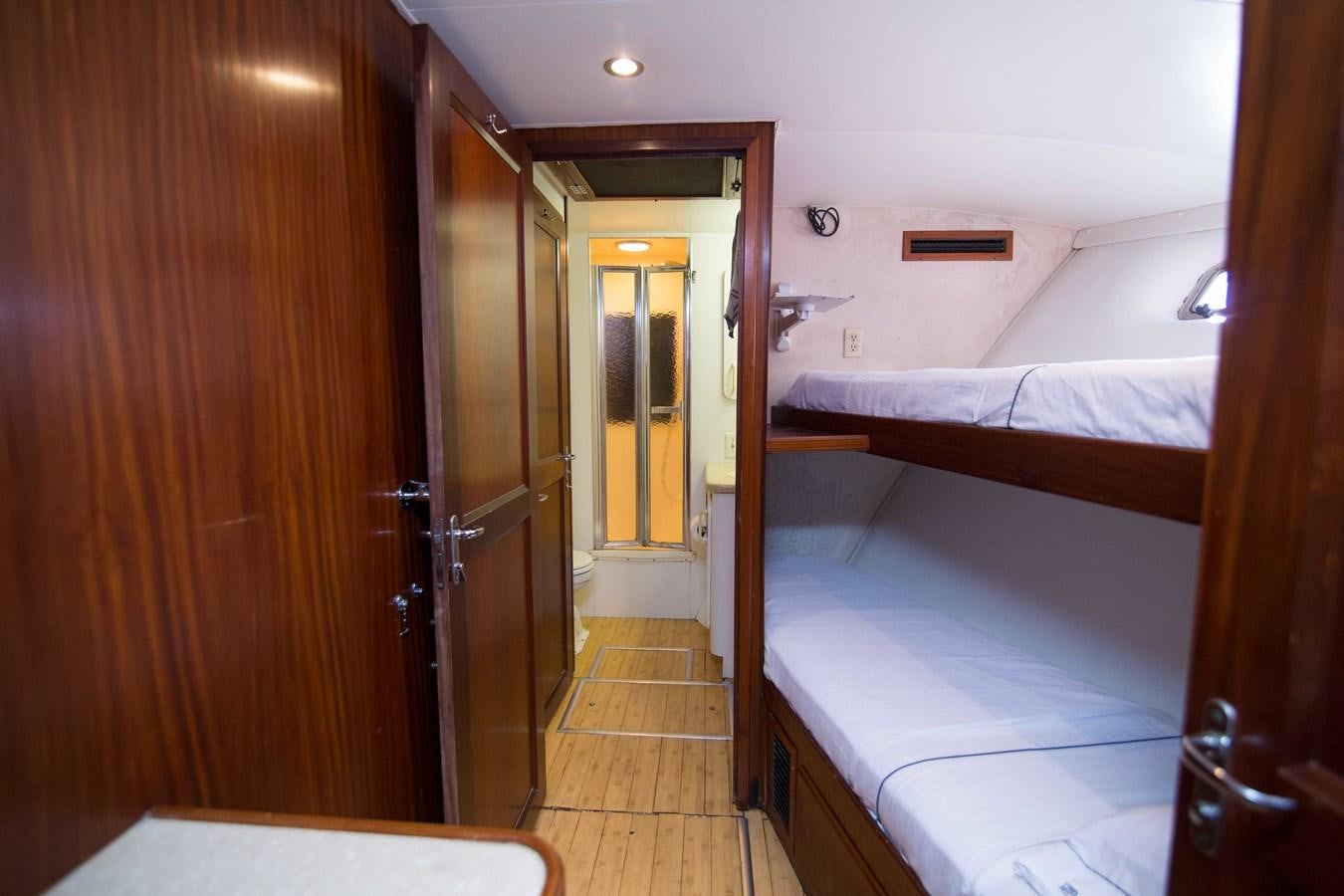 a room with a bed and a closet aboard NEXT DEAL Yacht for Sale