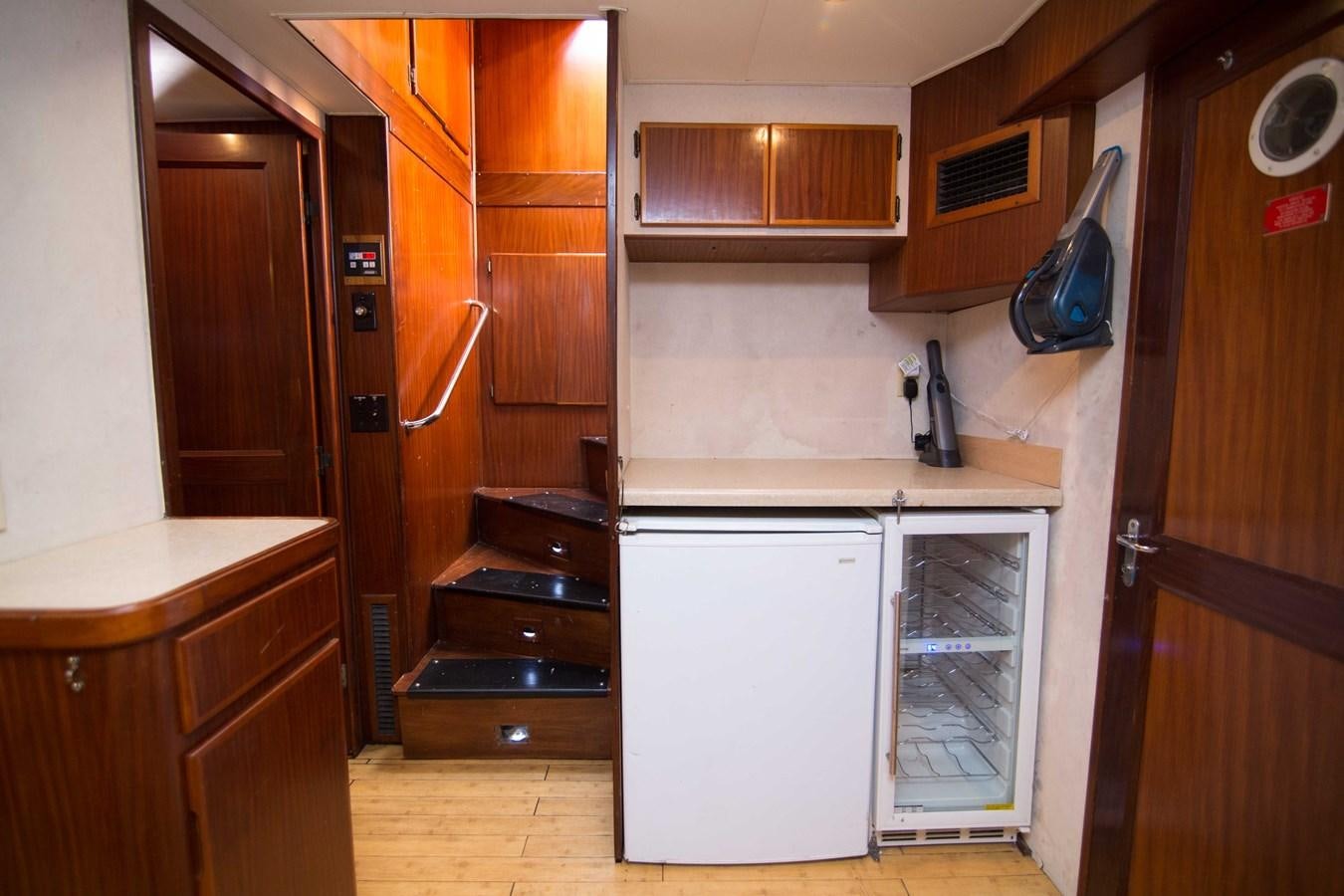 a kitchen with wooden cabinets aboard NEXT DEAL Yacht for Sale