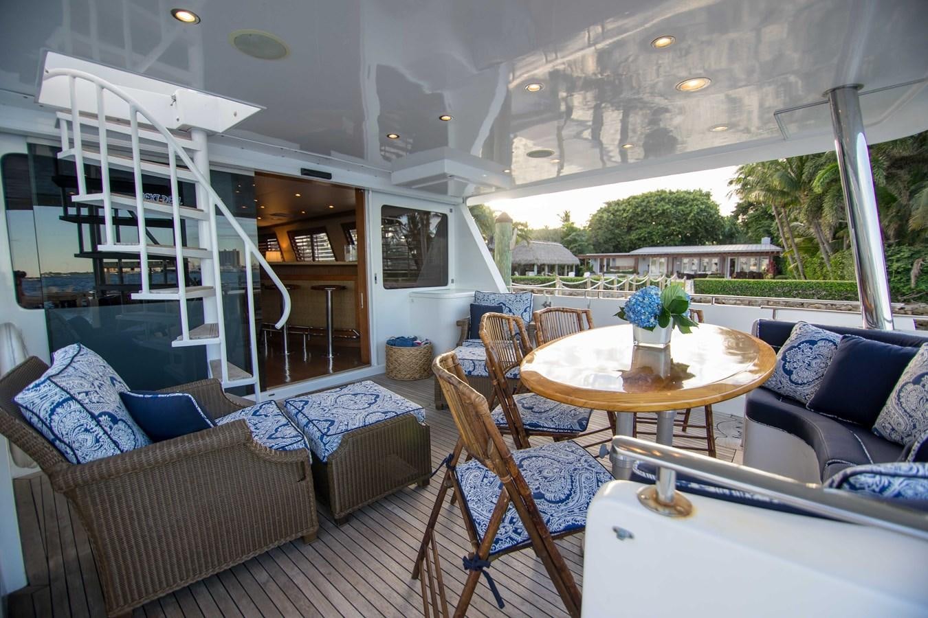 a living room with a staircase and a table aboard NEXT DEAL Yacht for Sale