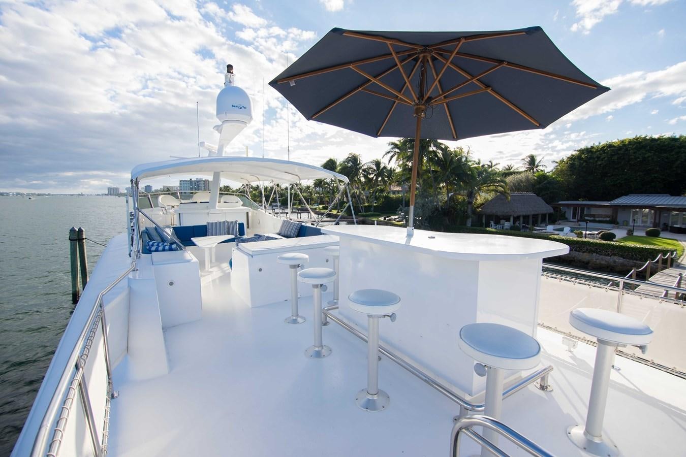 a boat with an umbrella aboard NEXT DEAL Yacht for Sale