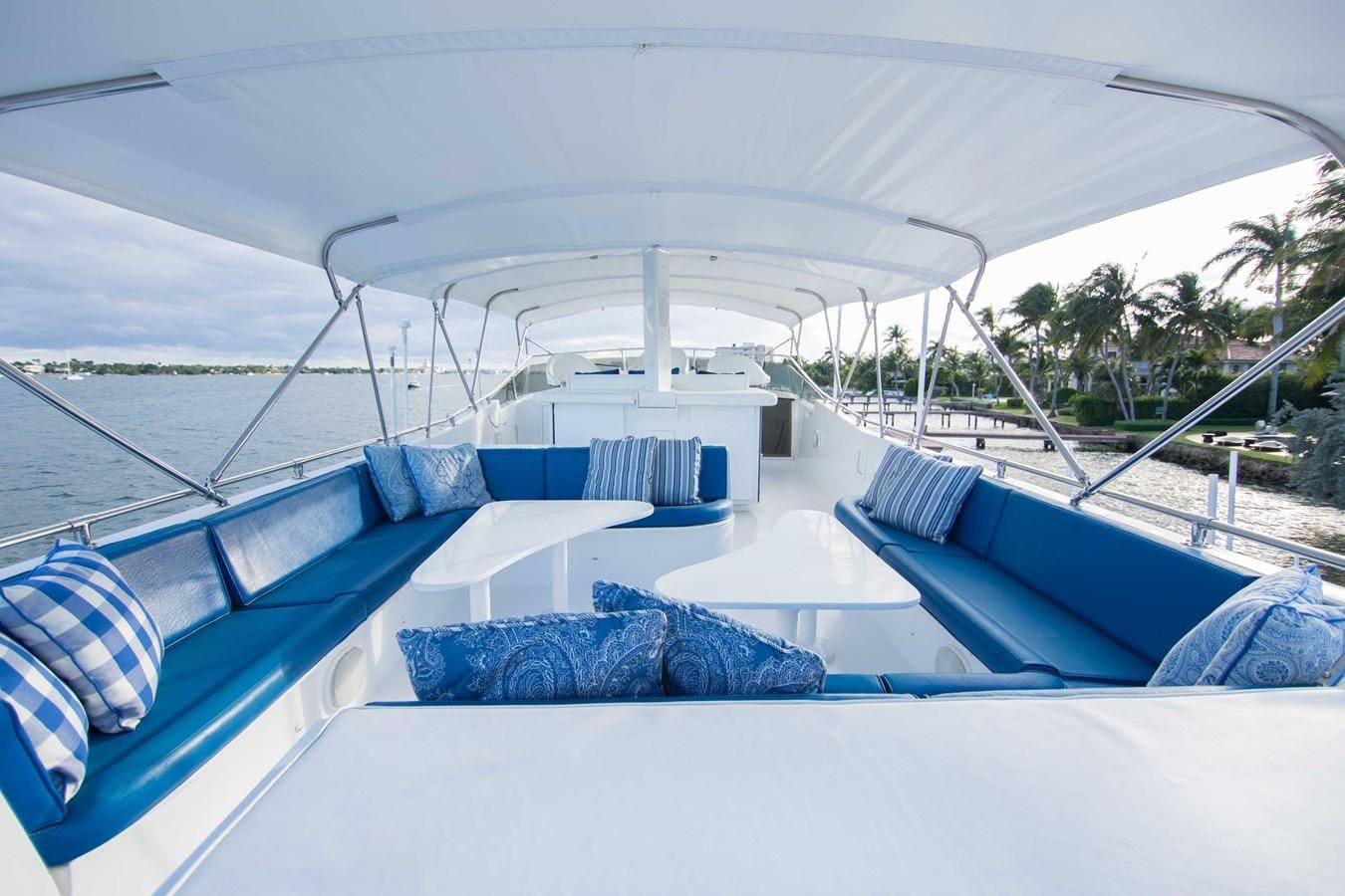 a pool with lounge chairs and a large white tent aboard NEXT DEAL Yacht for Sale