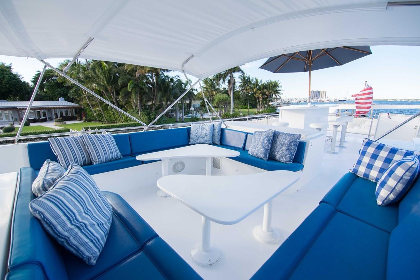 a pool with lounge chairs and umbrellas aboard NEXT DEAL Yacht for Sale