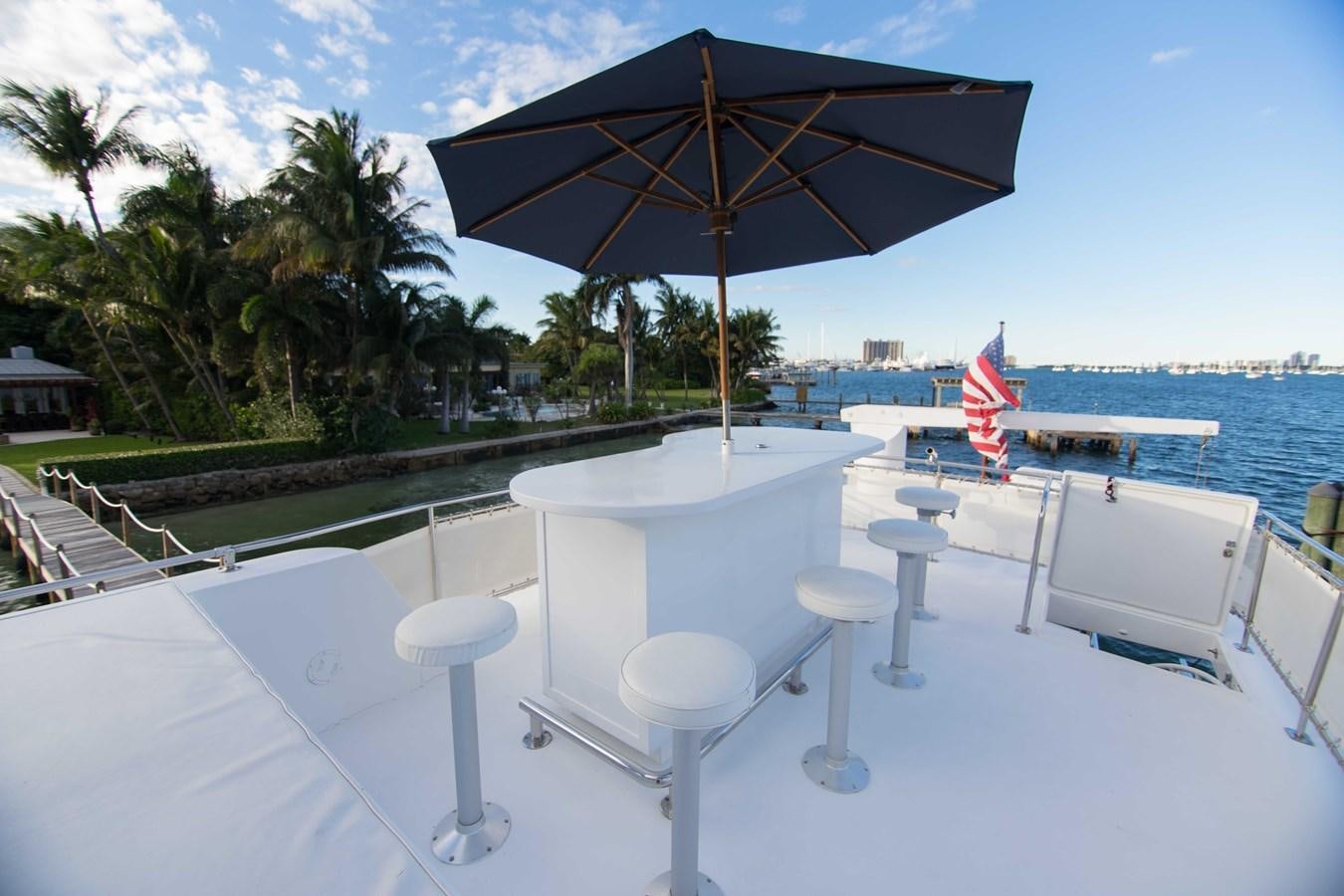 a table and chairs on a beach aboard NEXT DEAL Yacht for Sale
