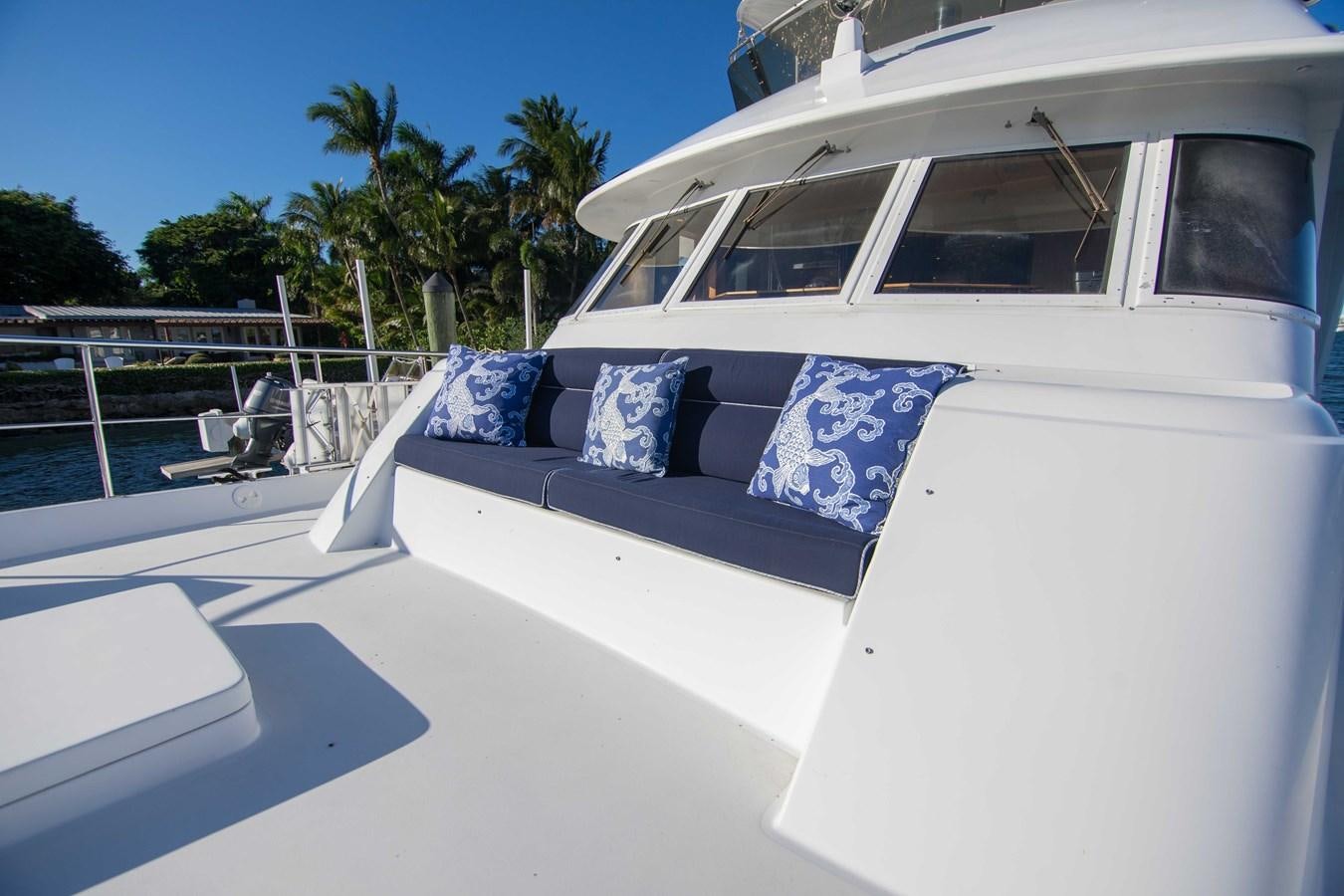 a white boat with a blue and white flag on it aboard NEXT DEAL Yacht for Sale