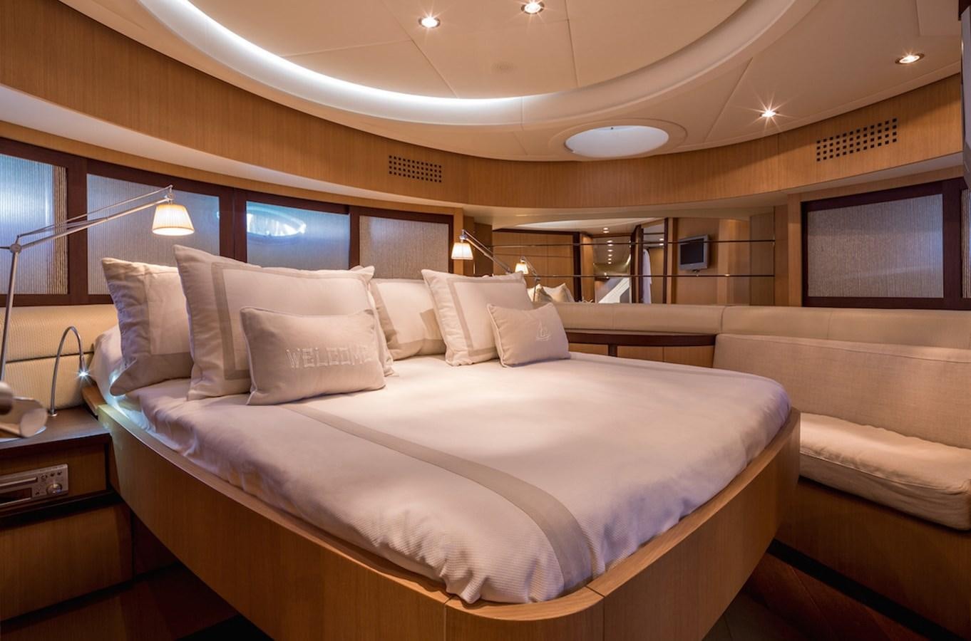 a bed with white sheets aboard ONE Yacht for Sale
