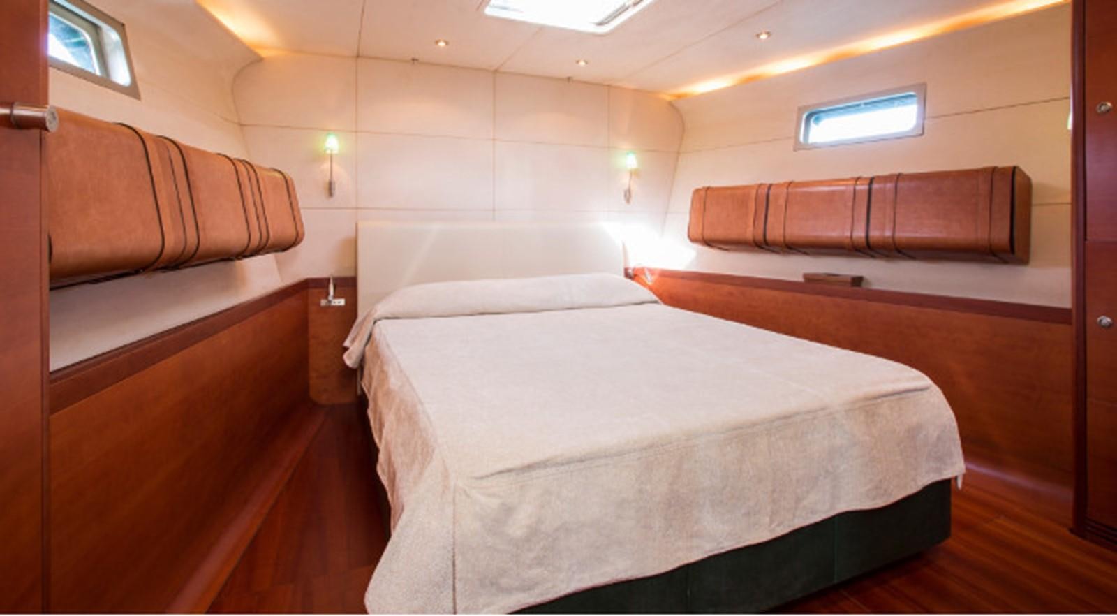 a room with a bed and a couch aboard ZURBAGAN Yacht for Sale