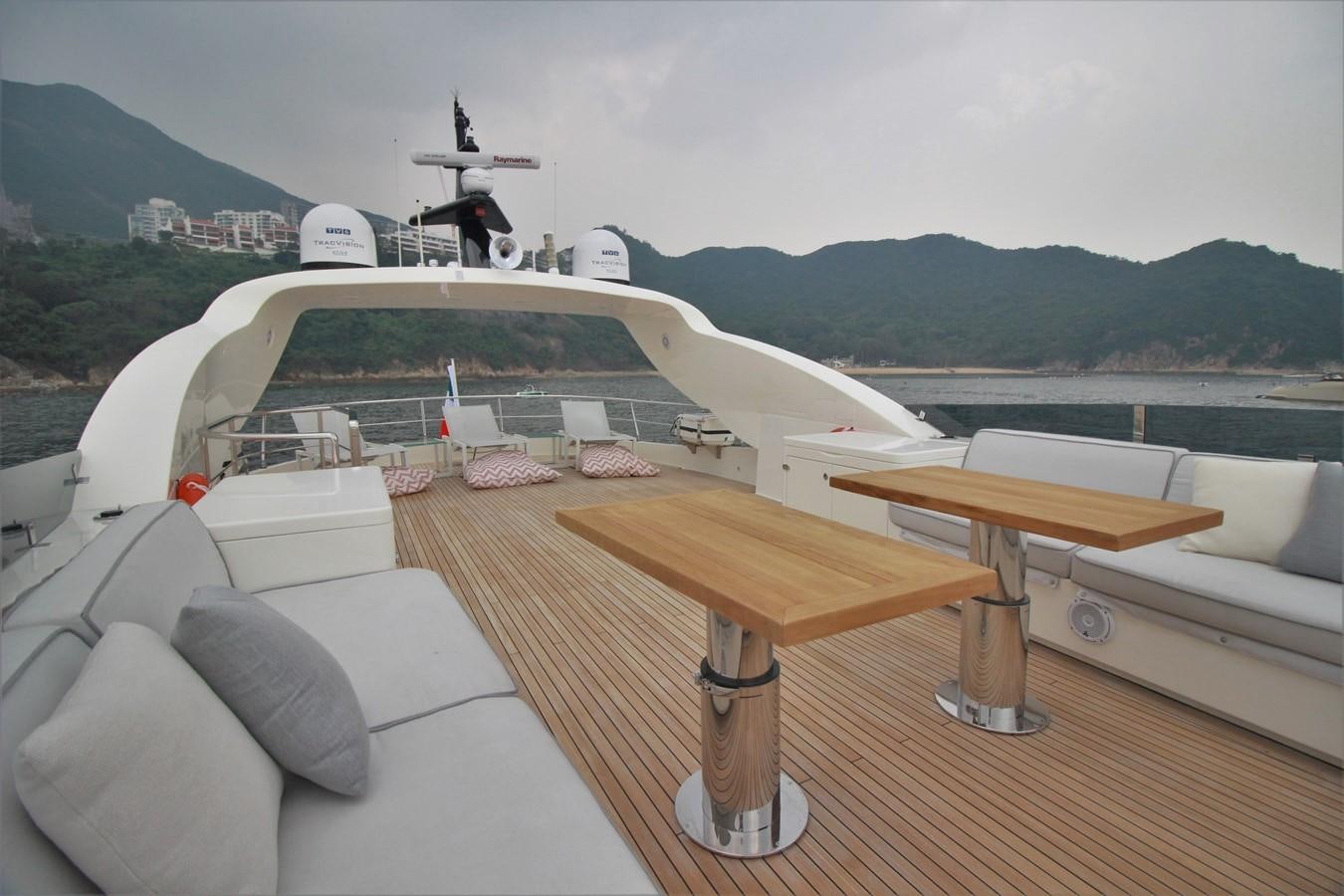 a deck with a table and chairs on it aboard VERSILCRAFT V86 Yacht for Sale