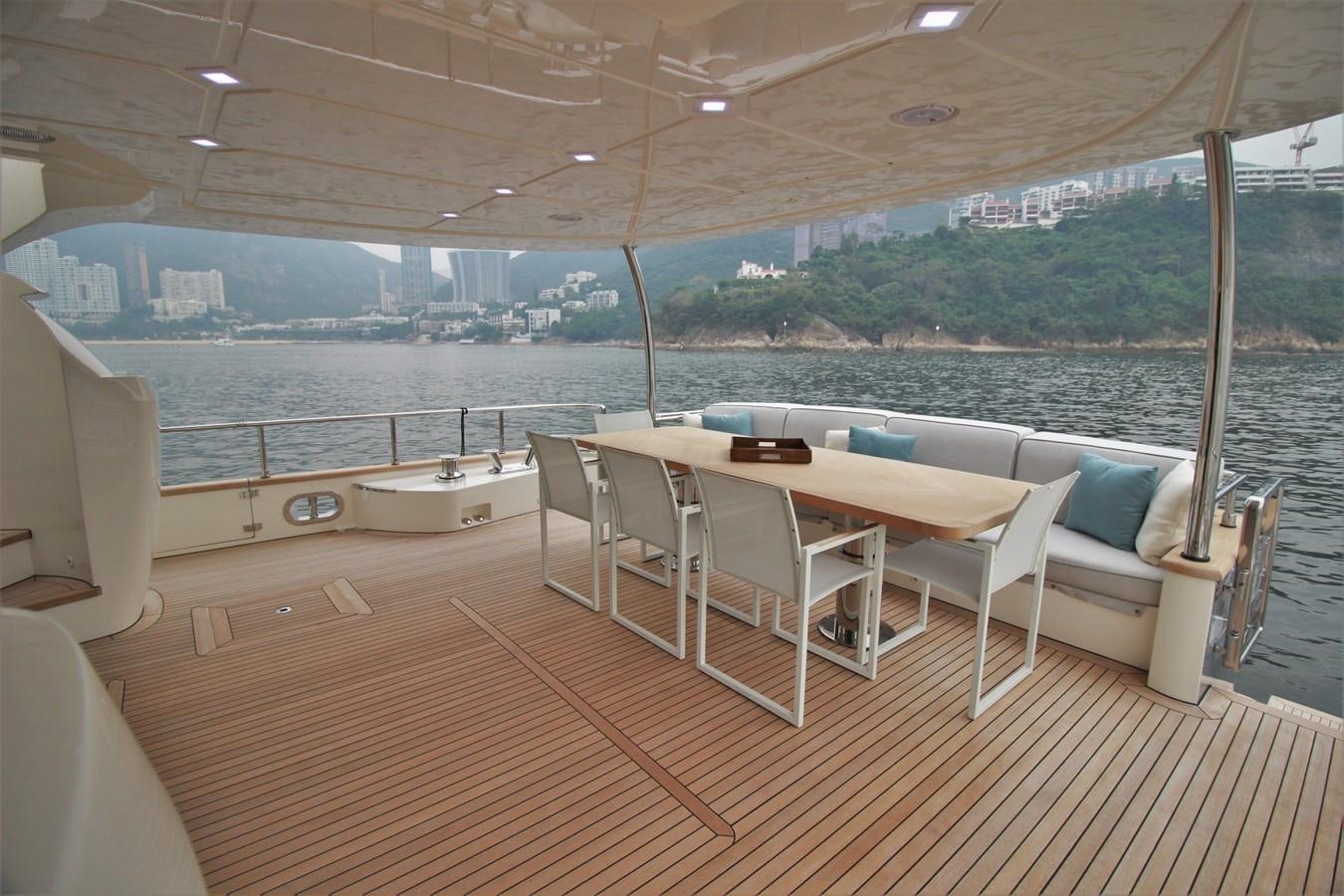 a room with a table and chairs aboard VERSILCRAFT V86 Yacht for Sale