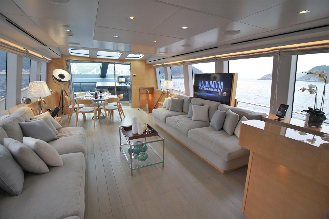 a living room with a large window aboard VERSILCRAFT V86 Yacht for Sale