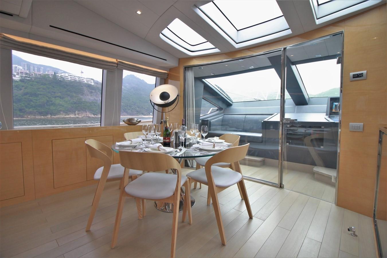 a dining table in a room aboard VERSILCRAFT V86 Yacht for Sale