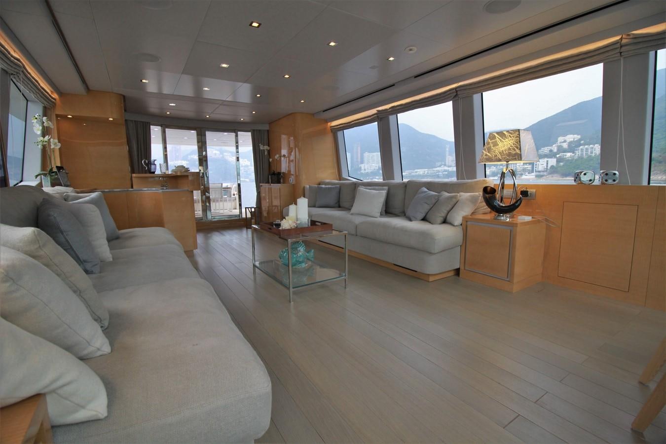 a living room with a large window aboard VERSILCRAFT V86 Yacht for Sale
