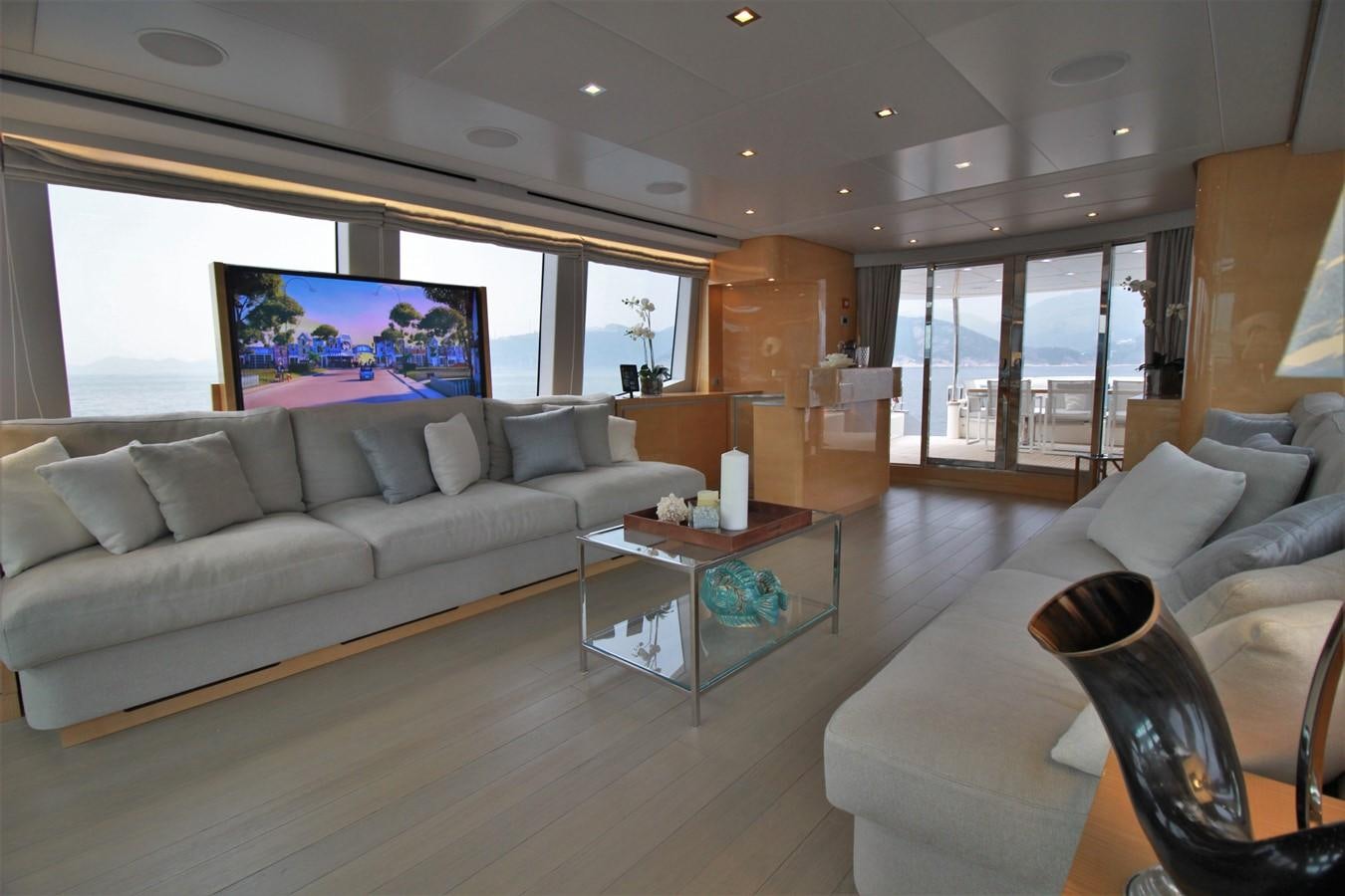 a living room with a large window aboard VERSILCRAFT V86 Yacht for Sale