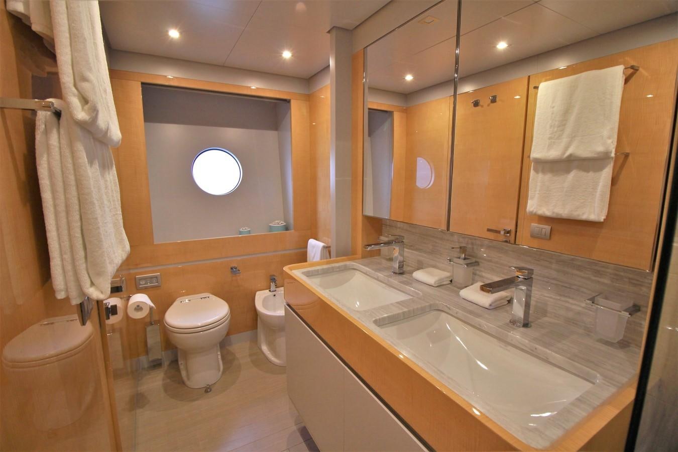 a bathroom with a sink toilet and a mirror aboard VERSILCRAFT V86 Yacht for Sale