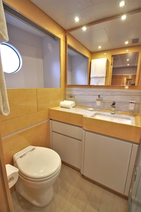 a bathroom with a toilet and a sink aboard VERSILCRAFT V86 Yacht for Sale