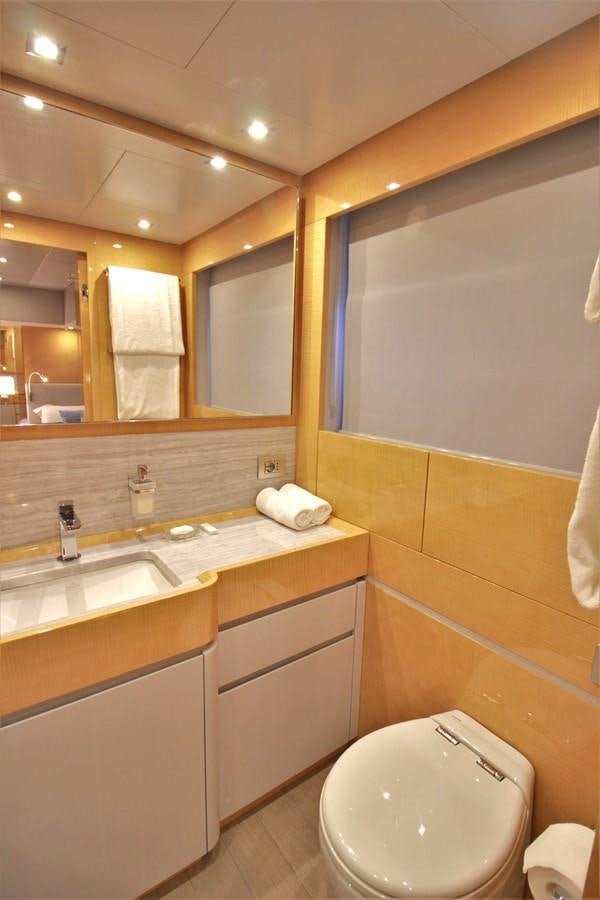 a bathroom with a mirror and a sink aboard VERSILCRAFT V86 Yacht for Sale
