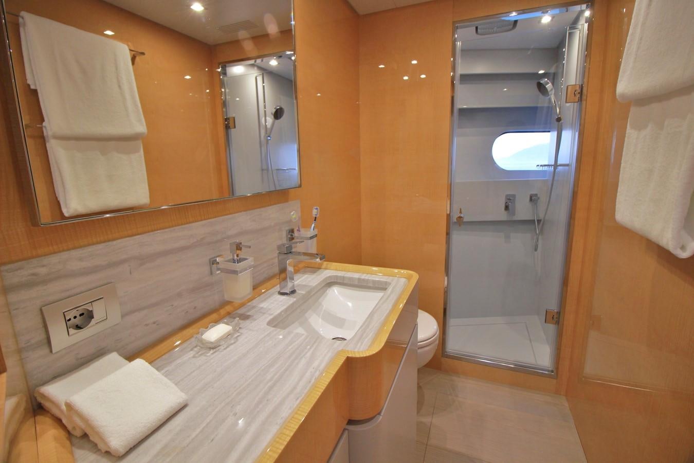 a bathroom with a sink and a shower aboard VERSILCRAFT V86 Yacht for Sale
