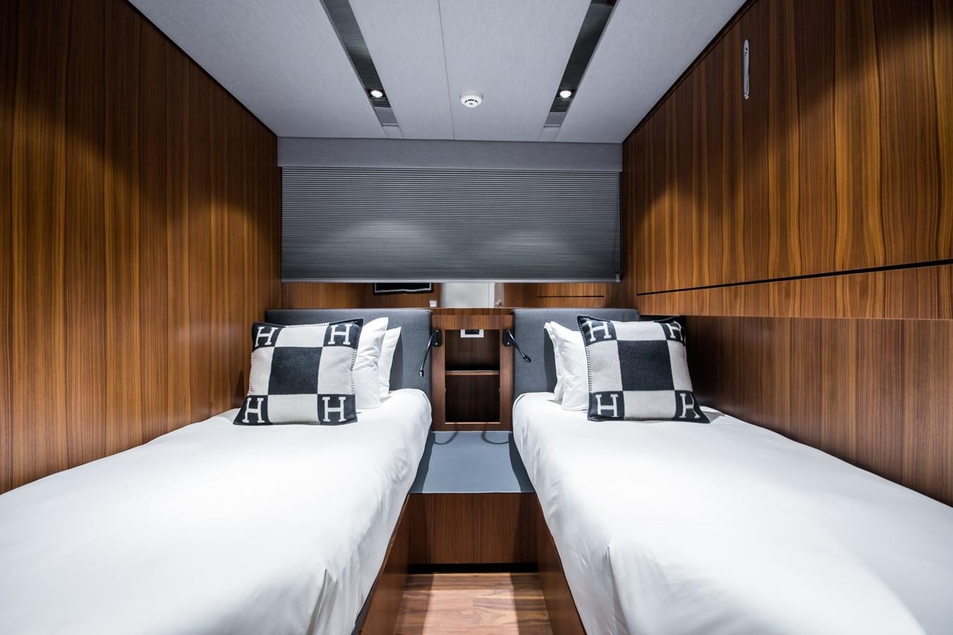 a room with beds and a wood wall aboard YXT 27 Yacht for Sale
