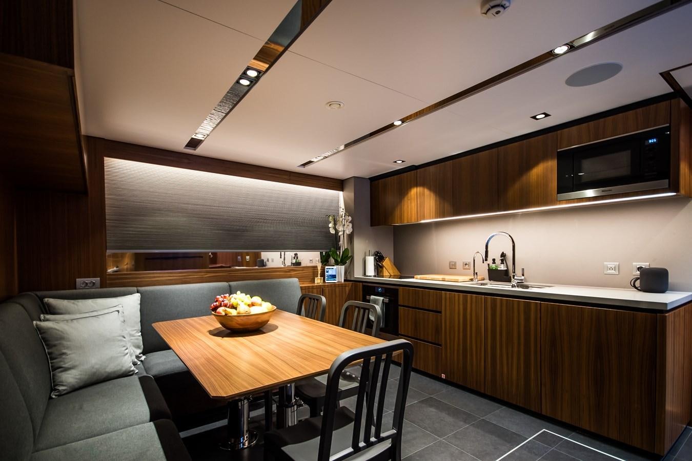 a kitchen with a table and chairs aboard YXT 27 Yacht for Sale