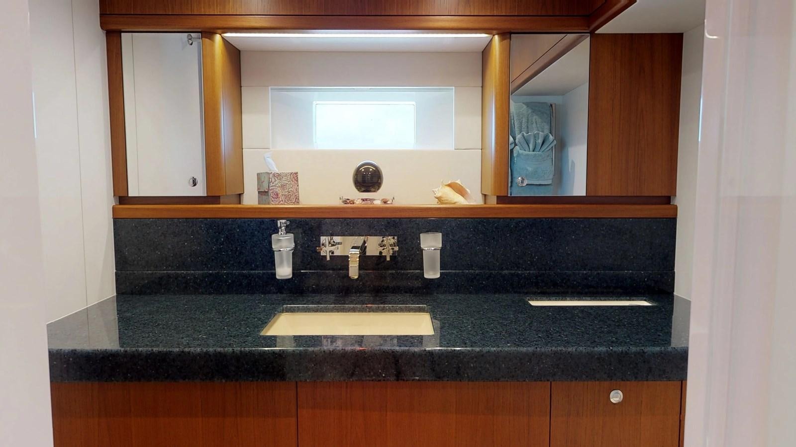 a bathroom with a sink and a mirror aboard AYNI Yacht for Sale