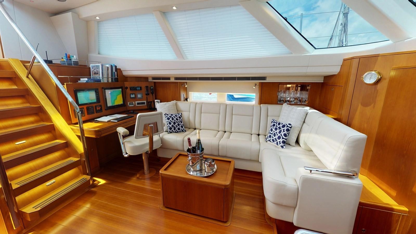 a living room with a couch and a piano aboard AYNI Yacht for Sale