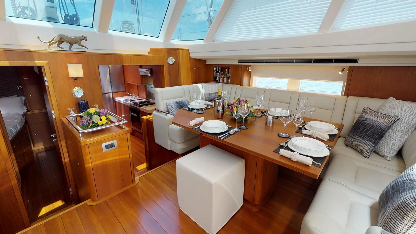a room with a table and chairs aboard AYNI Yacht for Sale