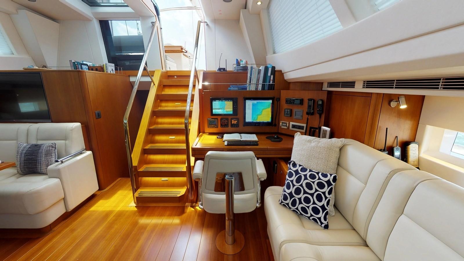 a living room with a couch and a table aboard AYNI Yacht for Sale